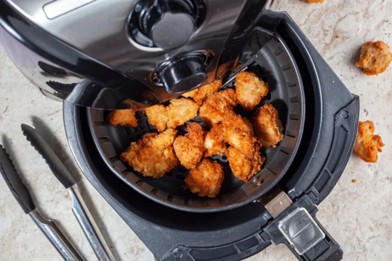 closeup image of crispy fried chicken in air fryer