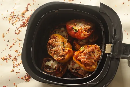 An image showing pocket pizzas in an air fryer.