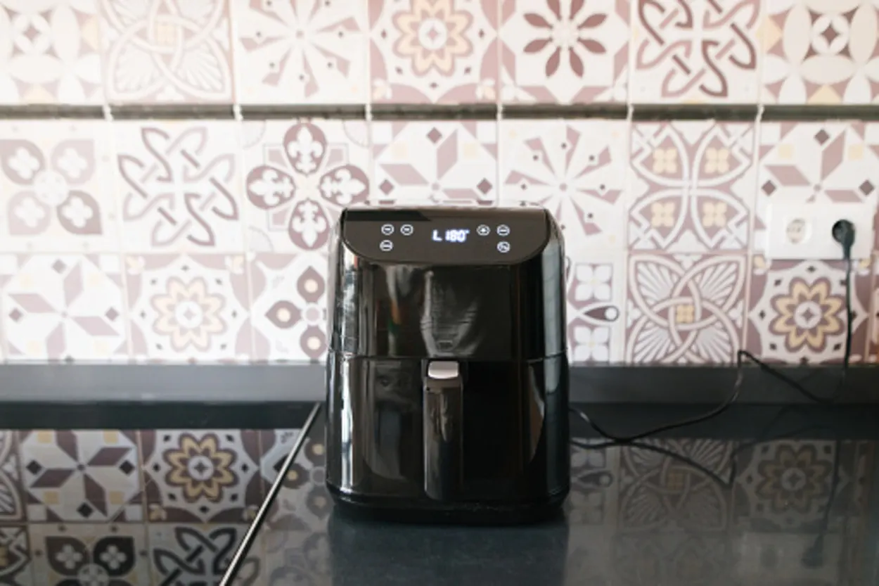 Black air fryer placed on a countertop