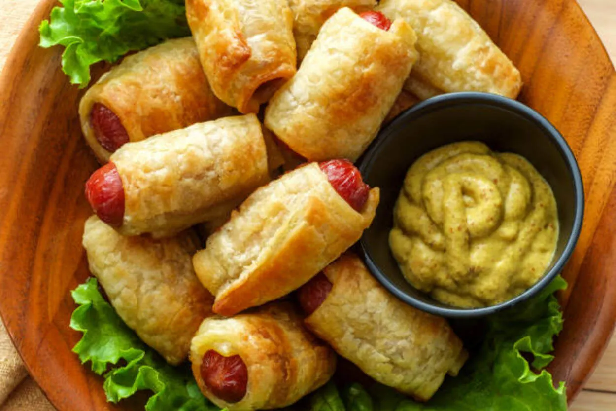 Pigs in a blanket served with a sauce
