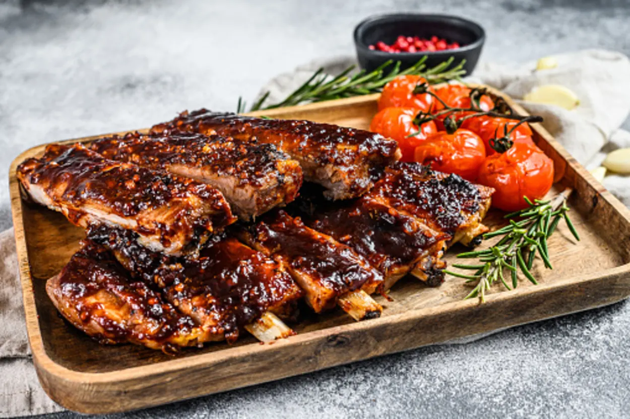 country style ribs placed on a wooden board.