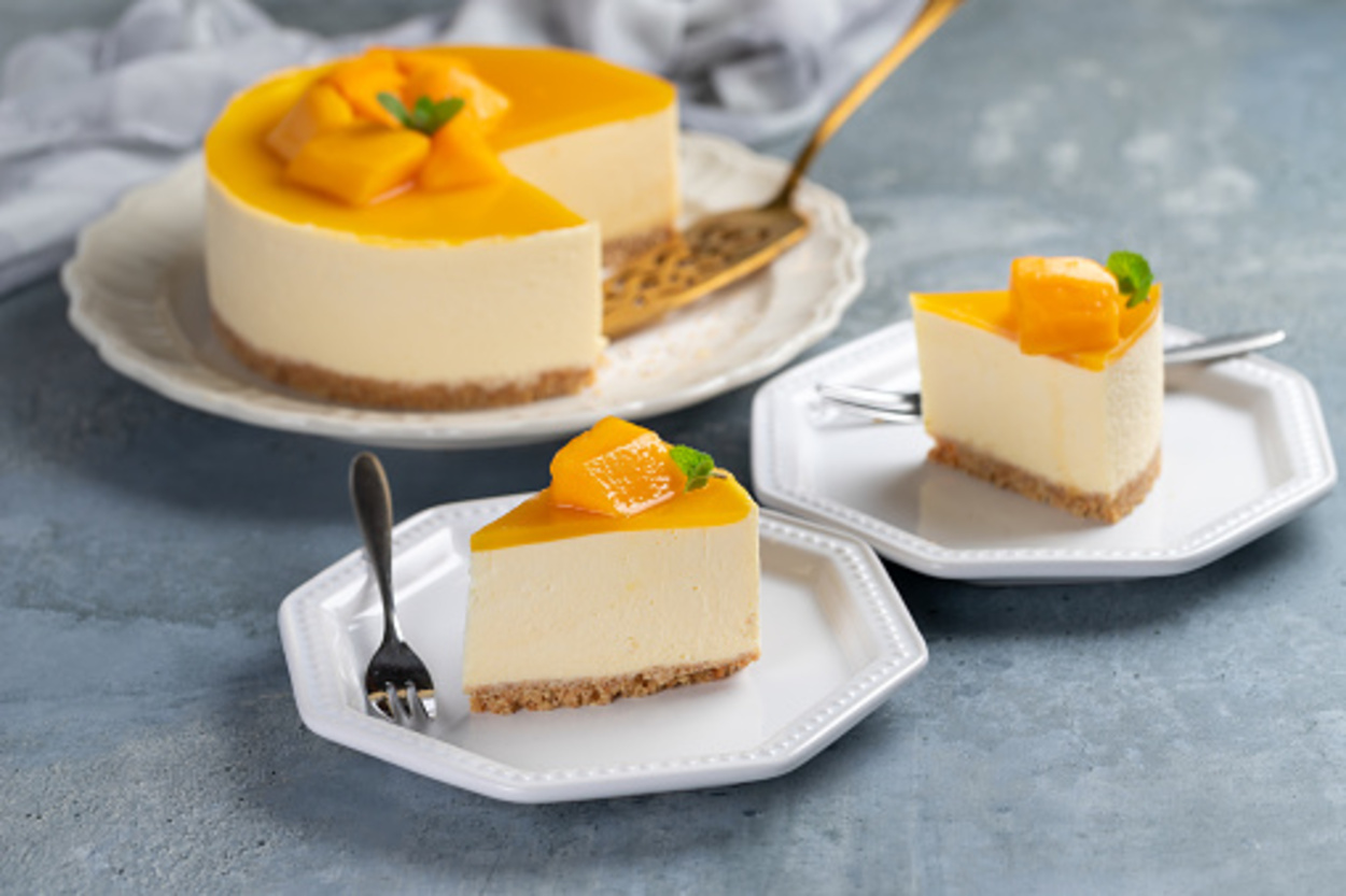 Mango cheesecake placed on white plate