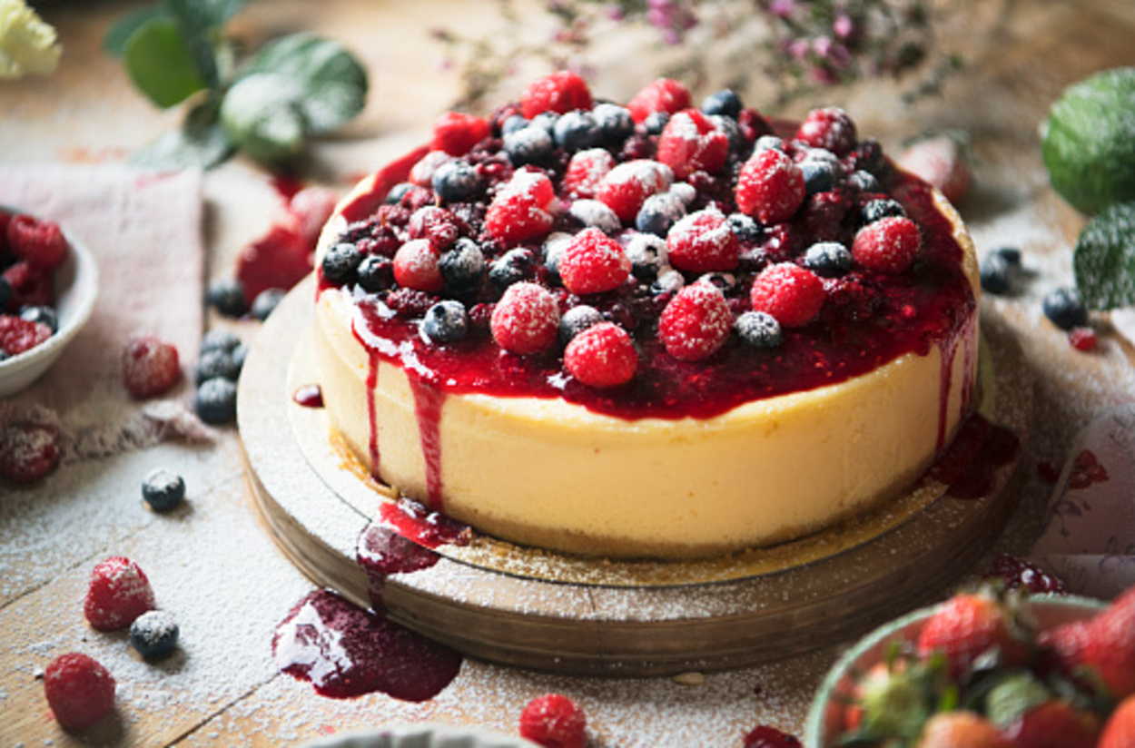 Fresh berries cheesecake on a wooden table