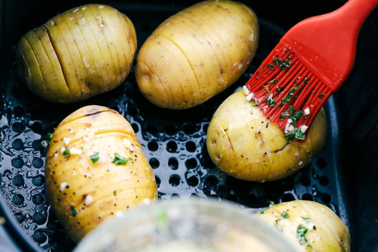 Brushing butter on the potatoes
