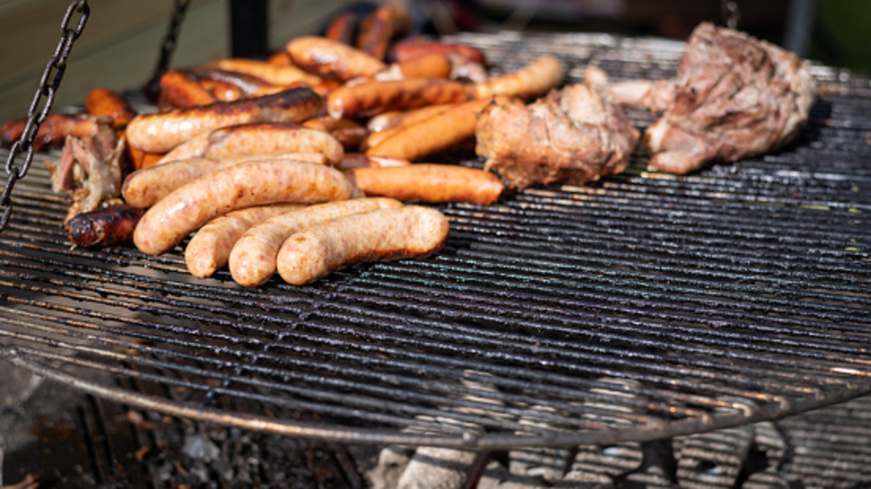 A closeup of sausages on the grill. 