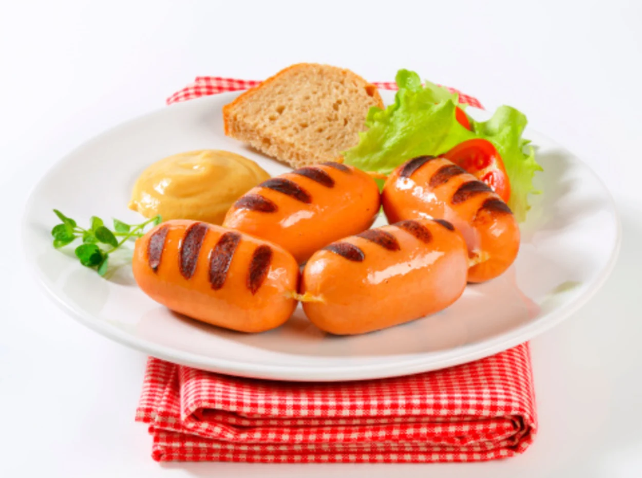 Grilled sausages served with bread and mustard.