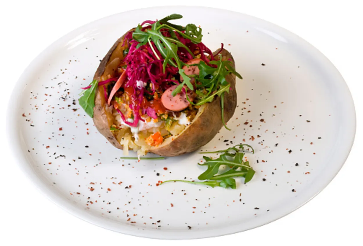 Baked potato topped with sausages and beetroot