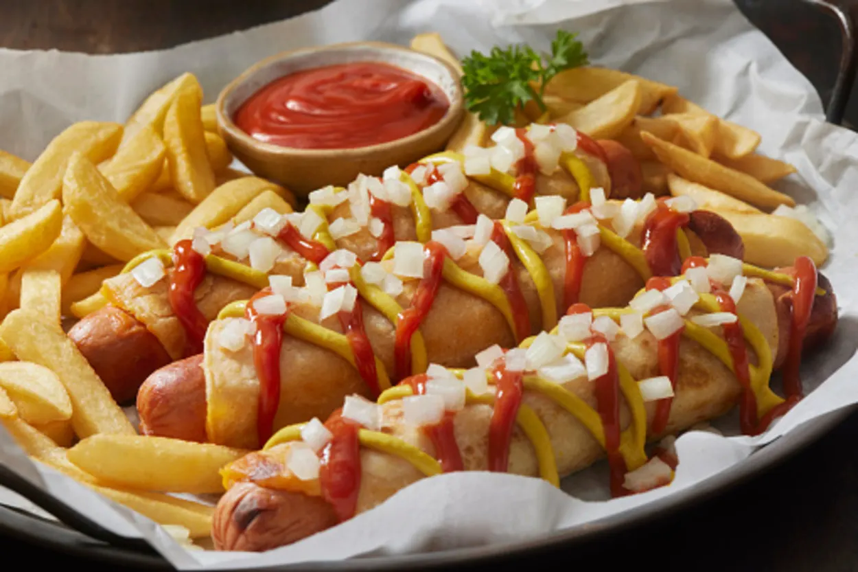 Sausages and fries topped with sauces