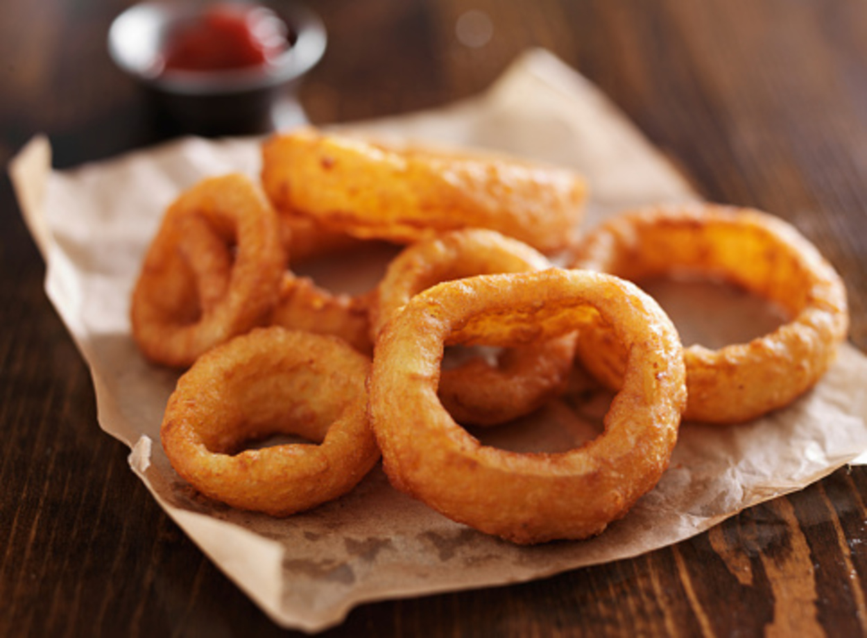 Onion rings placed on parchment paper