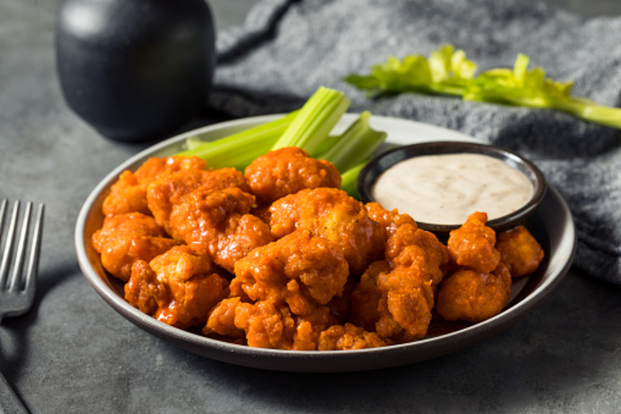 Buffalo wings with ranch in a plate