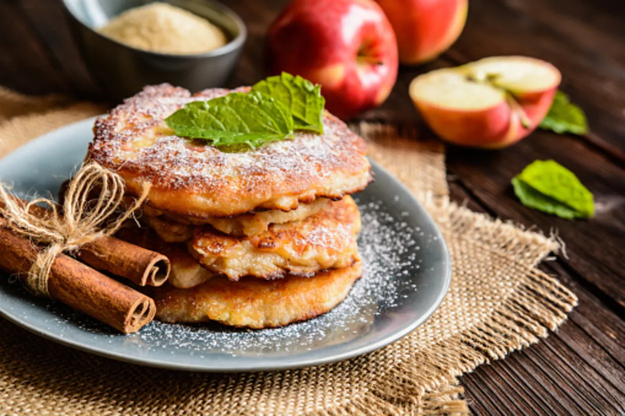 Stacked apple fritters with a piece of cinnamon