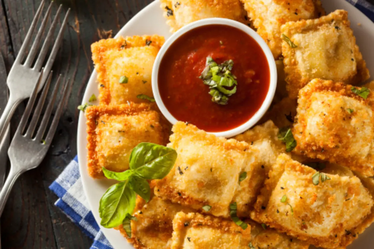 Air fried ravioli served with sauce