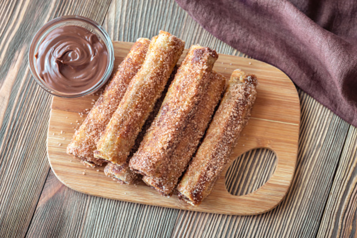 Nutella french toasts rollup on a wooden board