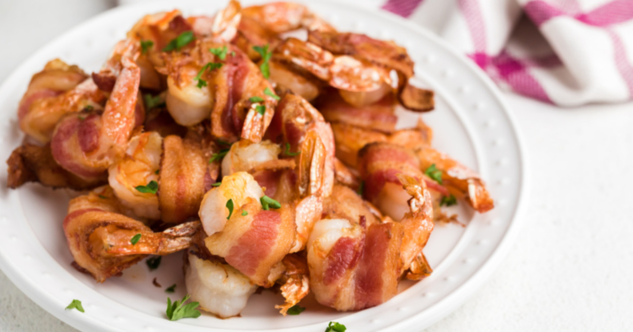 Bacon wrapped shrimp served in a round plate