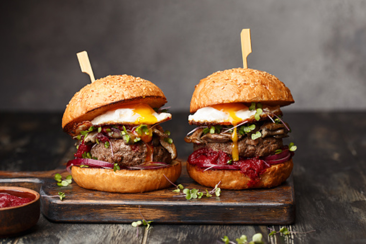 Loaded burgers on a wooden board