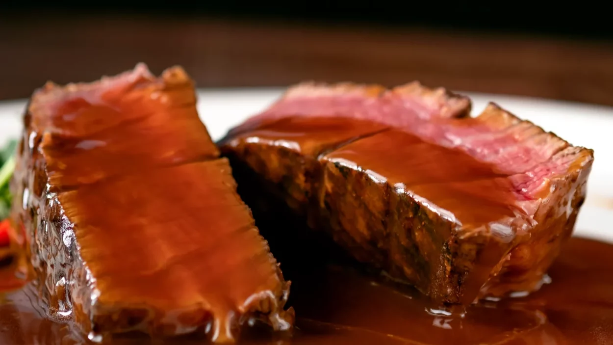 grilled beef steak filet mignon medium rare pour demiglace sauce