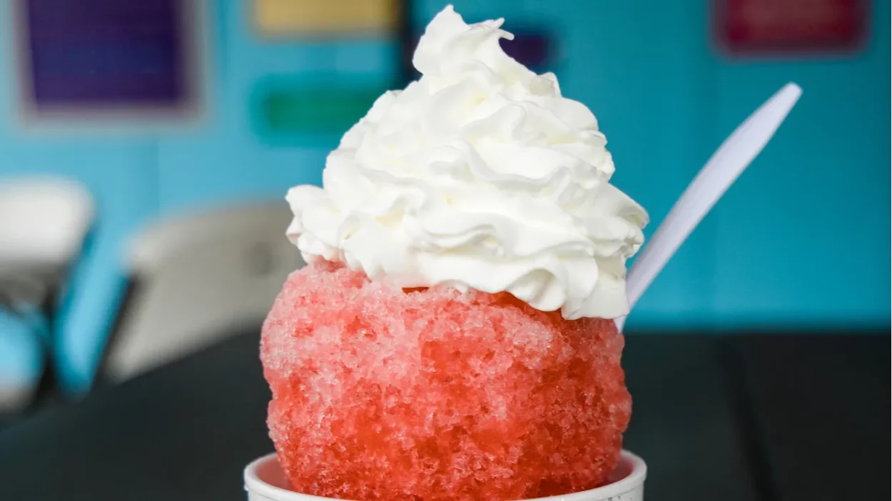 a vibrant red orange snowball or snocone shaved ice summer