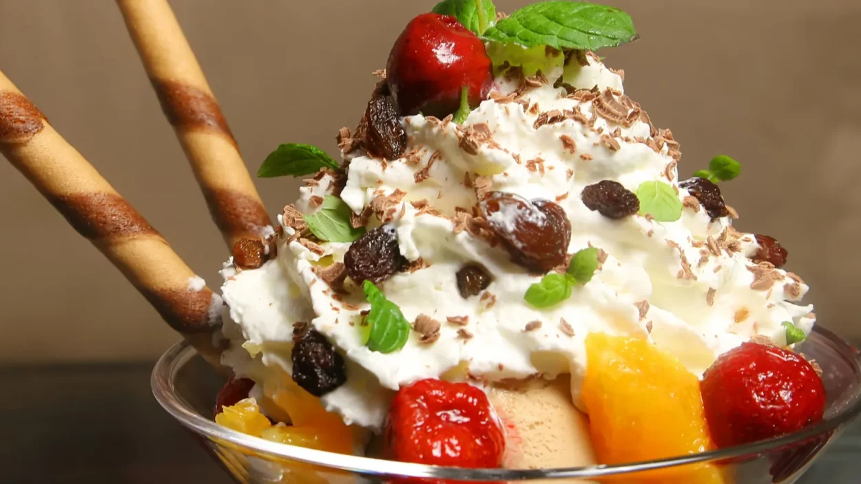 bowl with ice cream and fruits on the wooden table