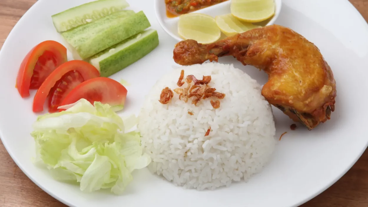 Fried Chicken ayam goreng served on white plate indonesian traditional food.