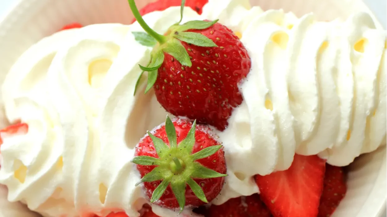 Healthy summer dessert with fresh strawberries and cream.