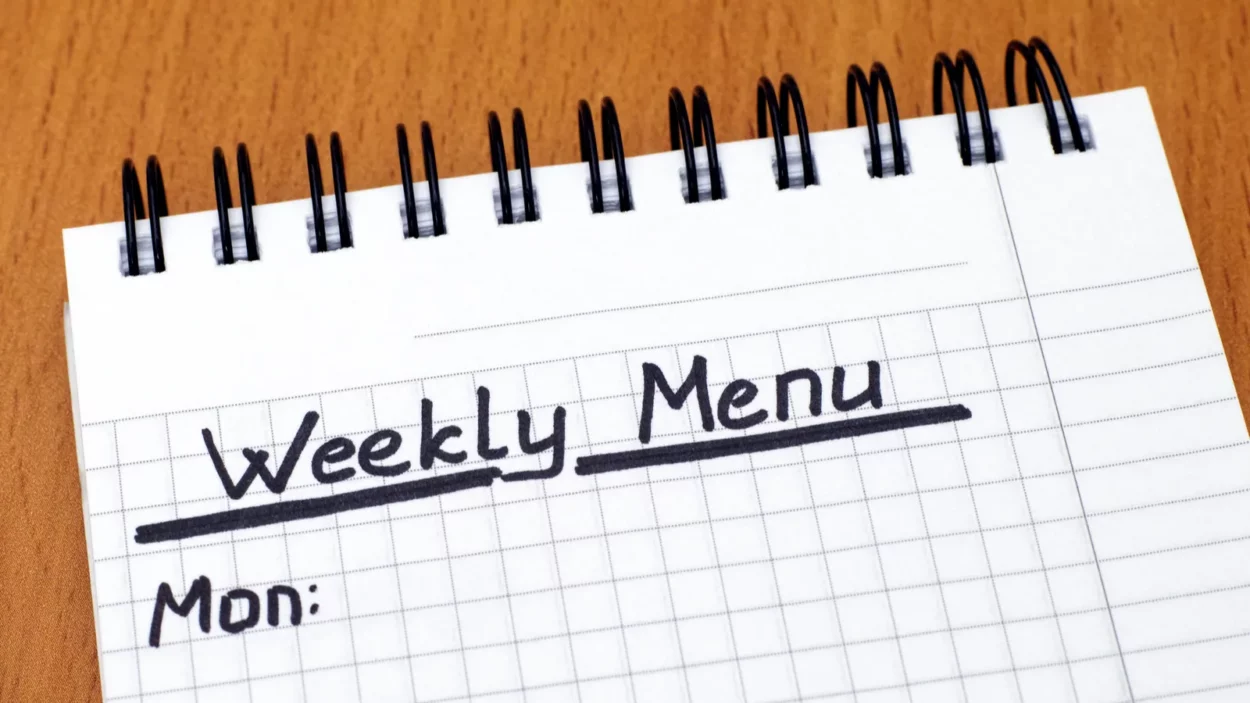 words weekly menu written on white note pad with pen