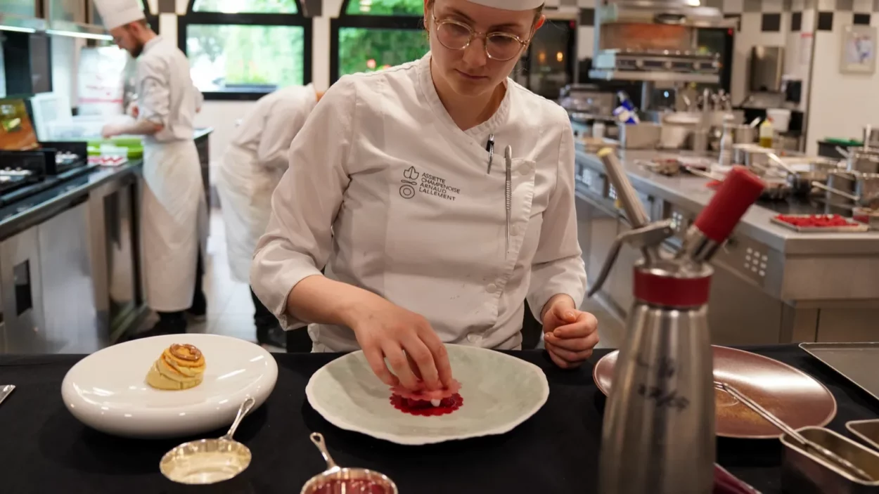 Pastry chef plating dessert dish at the Three Star Michelin L'Assiette Champenoise restaurant.