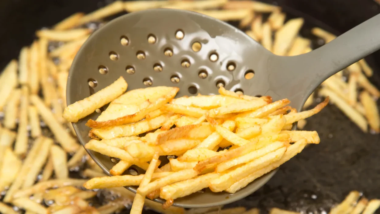 Cooking potato fries in oil.