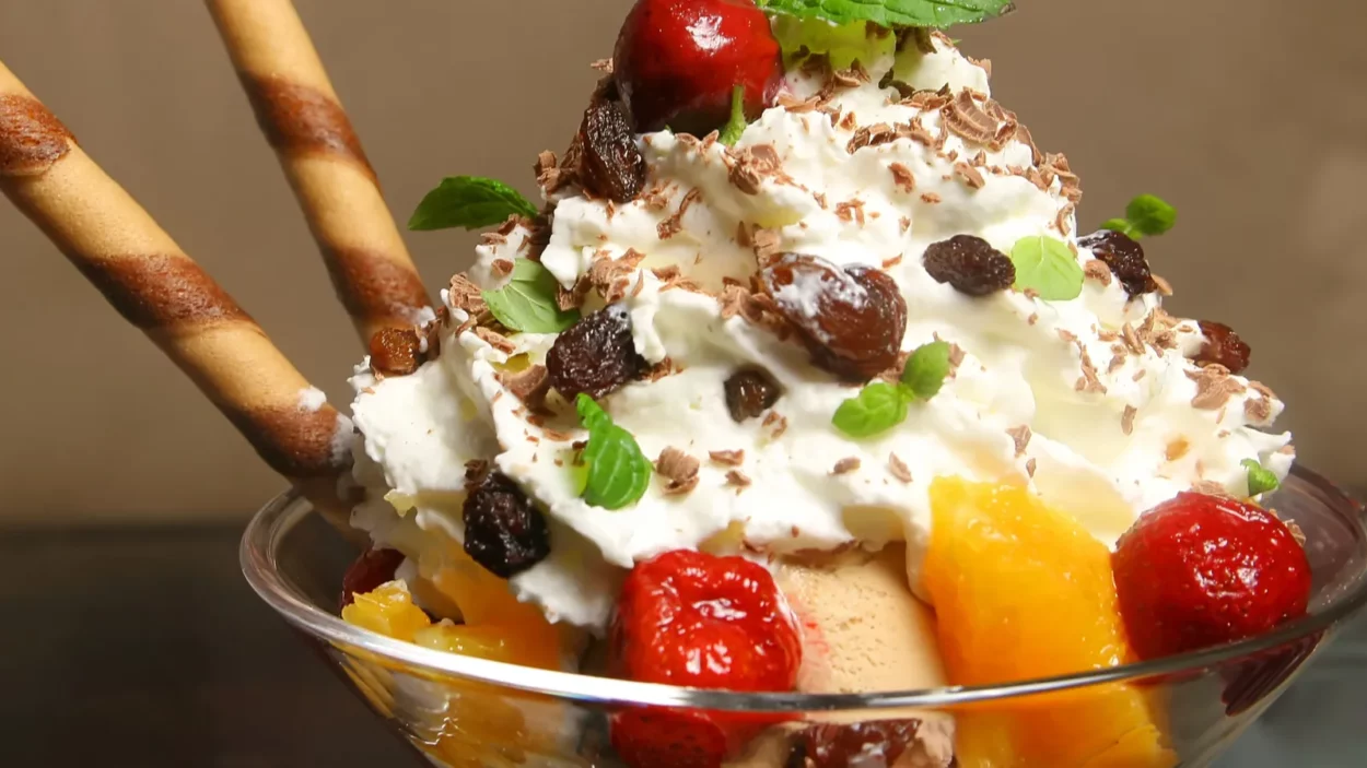 bowl with ice cream and fruits on the wooden table
