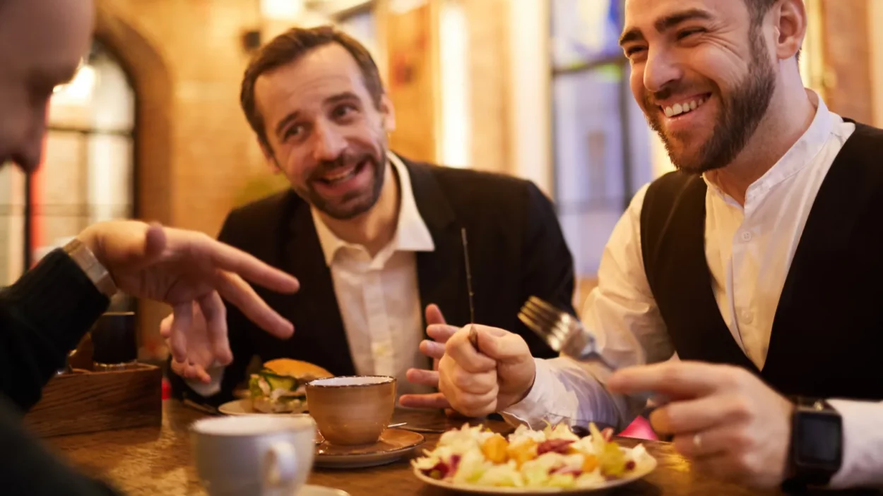 group of cheerful business people enjoying food and conversation in
