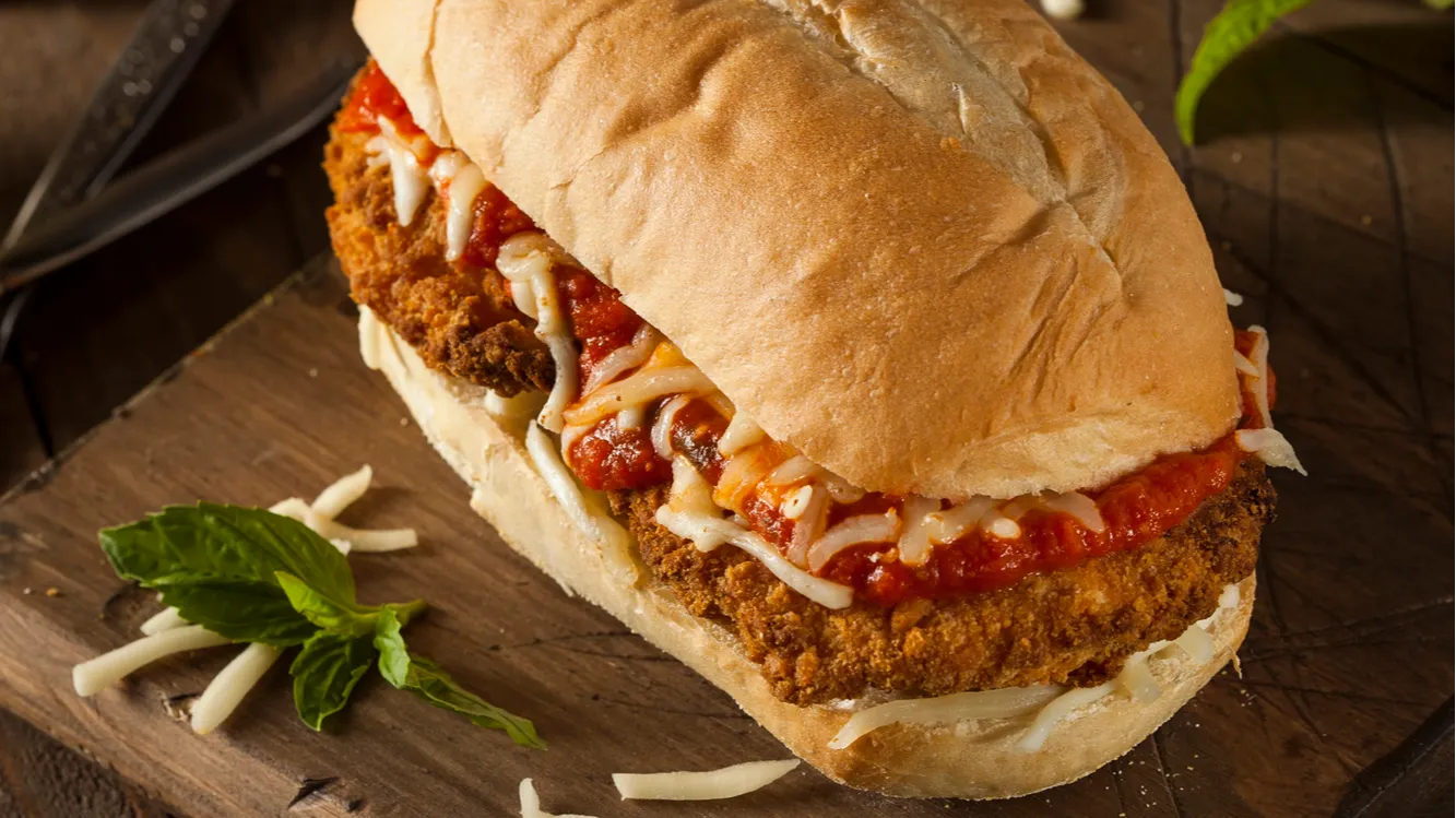 Homemade chicken parmesan sandwich with marinara and cheese.