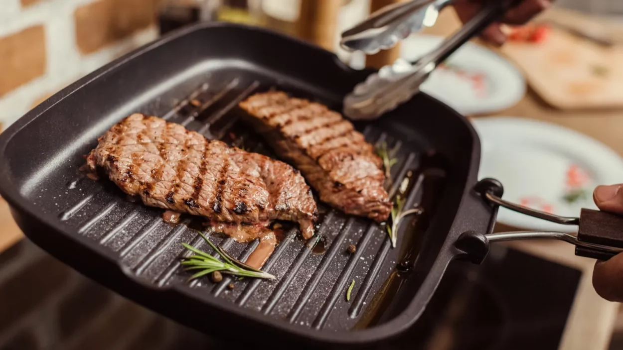 Man cooking steaks.