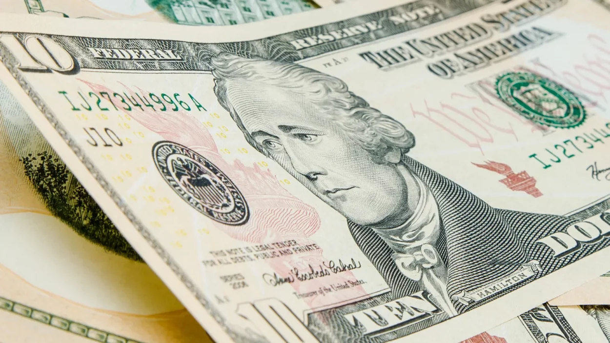 US Dollars background with focus on Alexander Hamilton.