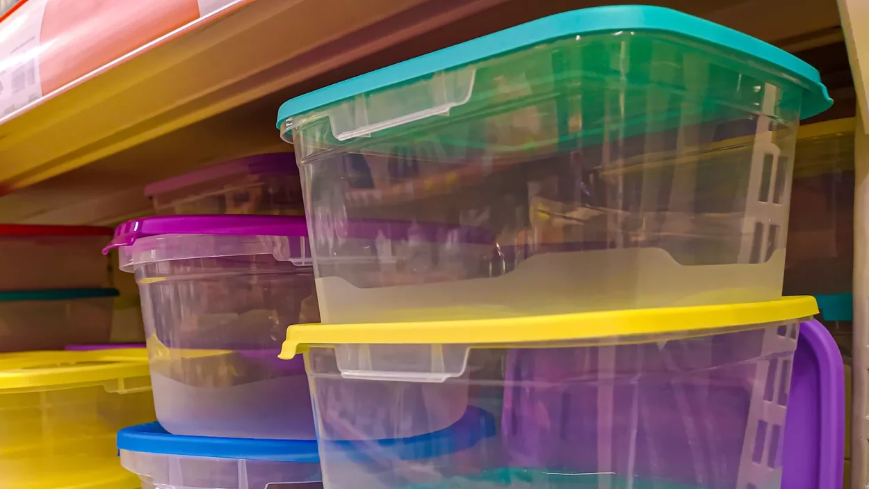 Plastic food containers on a shelf in a store.