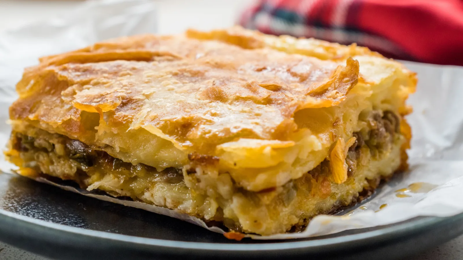 turkish borek with minced meat and leek on wooden board
