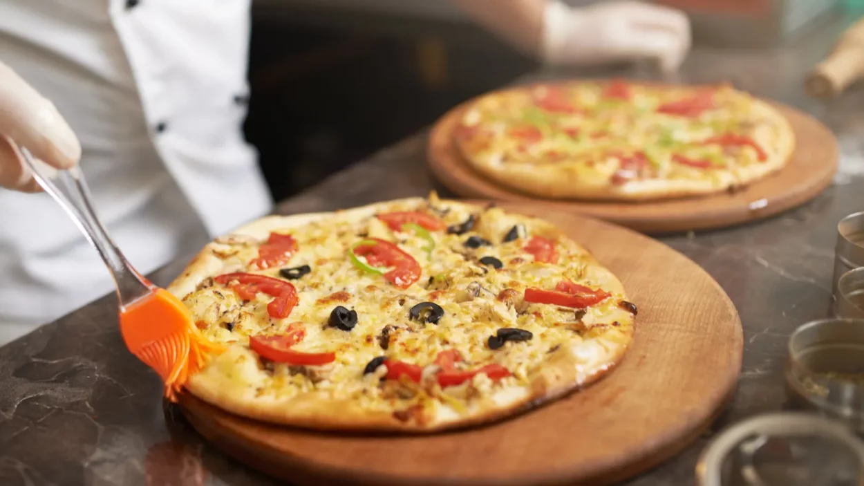 Cook misses edge prepared pizza.