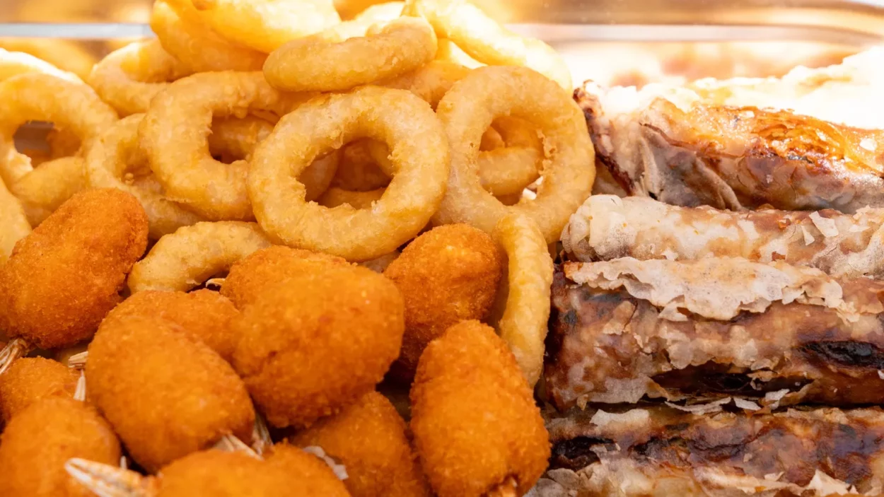 fried asian snacks on display featuring crispy onion rings tempura