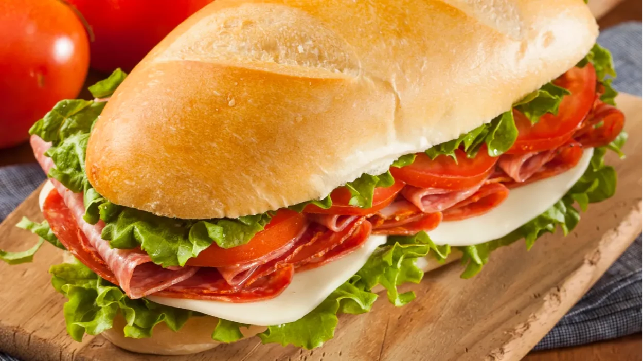 Homemade Italian sub sandwich with salami tomato and lettuce.