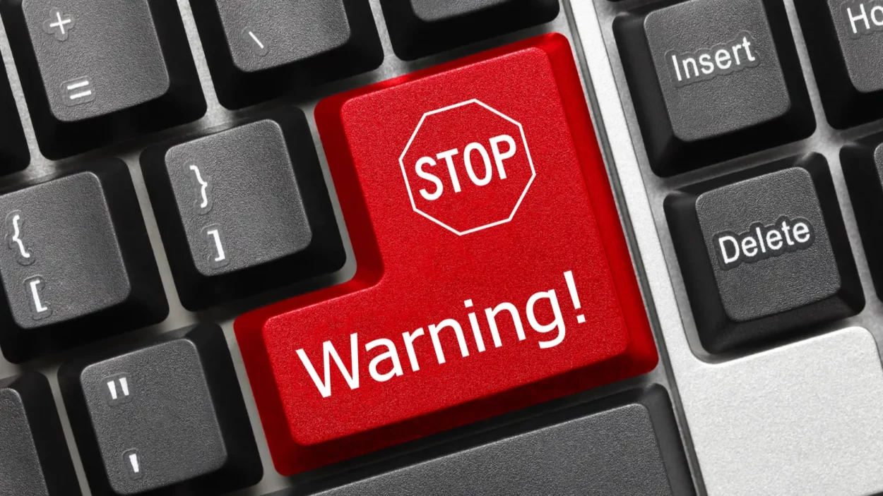 Close up view on conceptual keyboard - Warning (red key with stop sign).