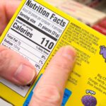 ATLANTA, GEORGIA - DECEMBER 16, 2024 : Candy ingredients label featuring petroleum based artificial food dyes including colors Red 40, Blue 2, Yellow 5, and Yellow 6.